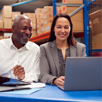 man and woman working in a warehouse