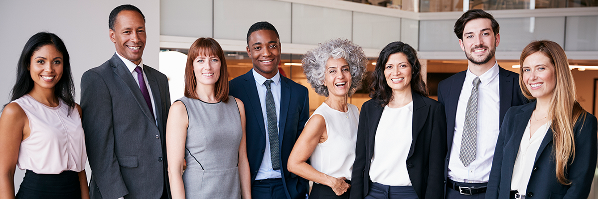 Photo of professionals smiling into camera