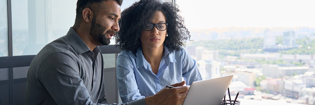 Two people looking at a screen.